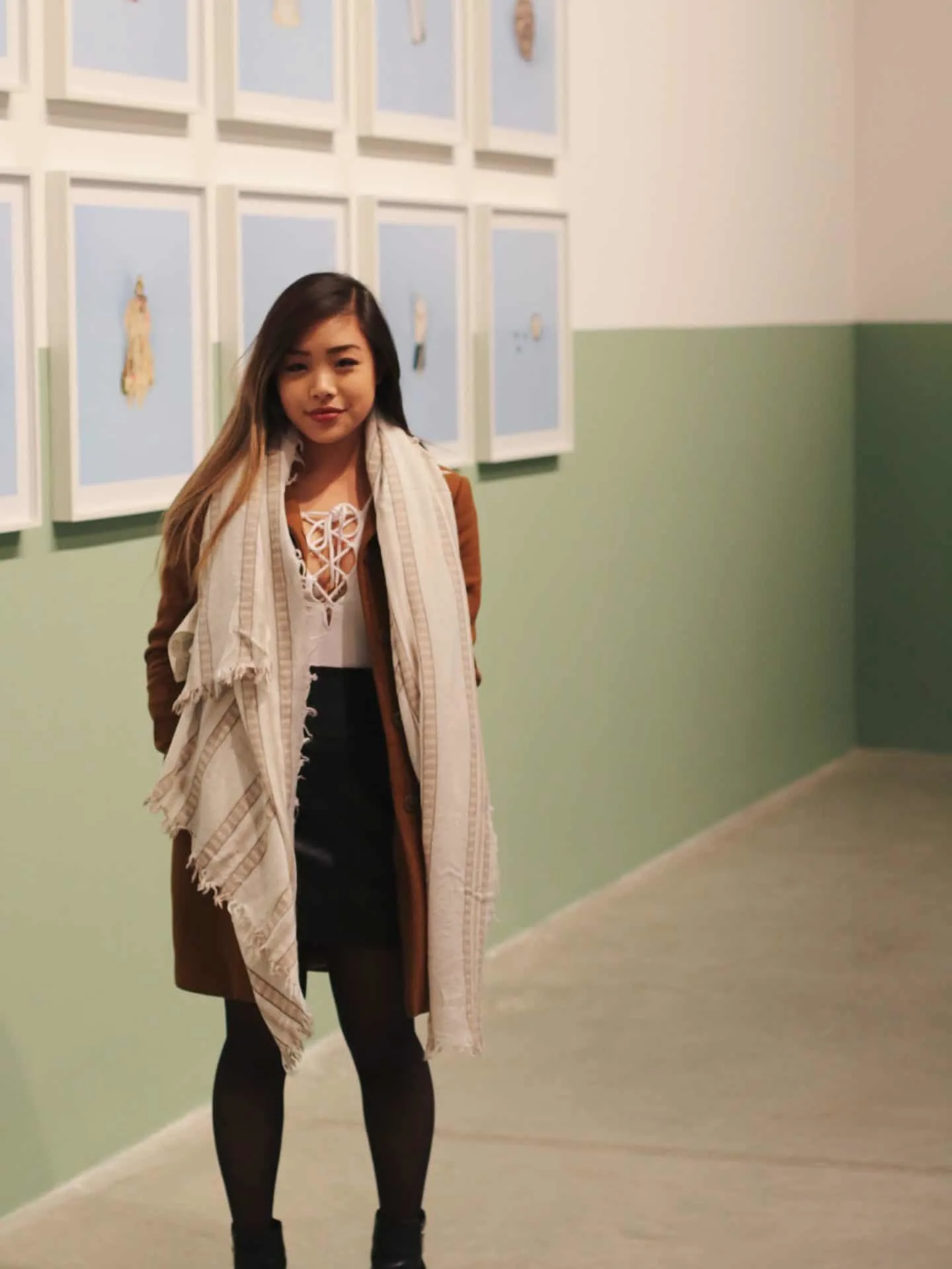 Winter outfit featuring white lace up bodysuit and black leather skirt