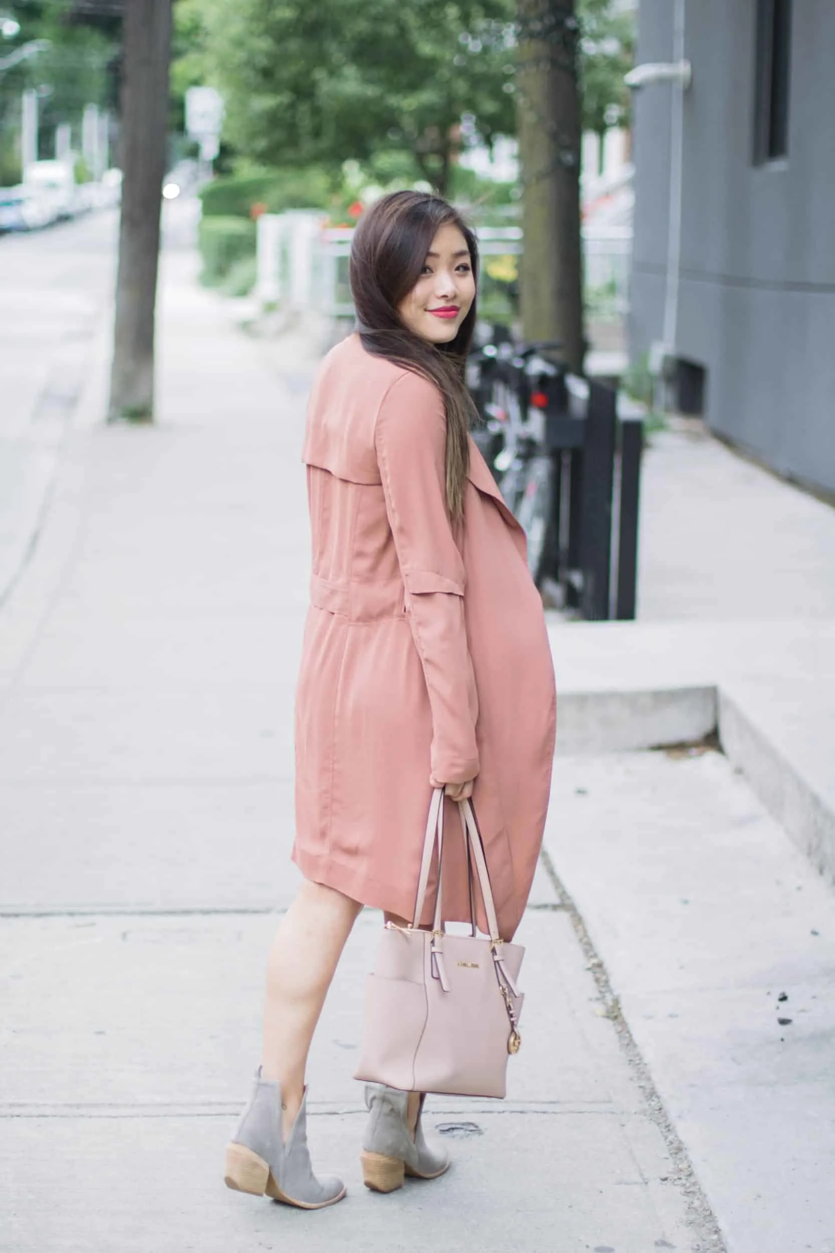 Summer outfit featuring Aritzia pink trench coat, Jeffrey Campbell grey suede booties, and nude Michael Kors bag