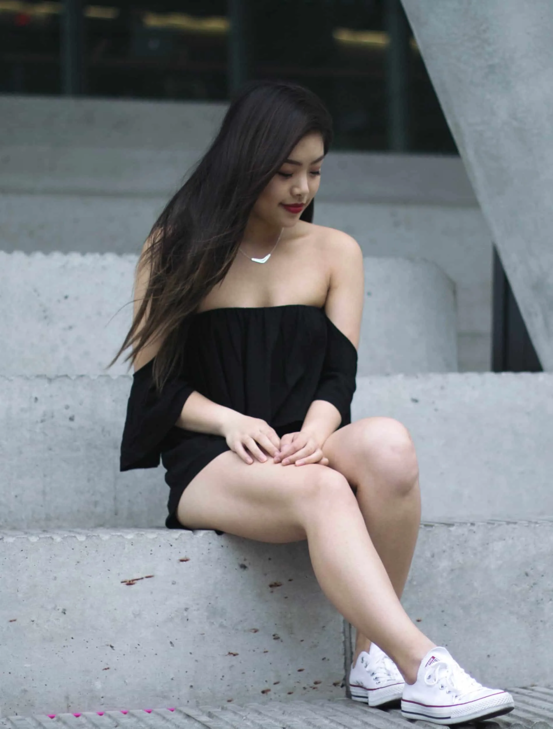 Summer outfit featuring black off-the-shoulder romper and white Converse Chuck Taylor sneakers