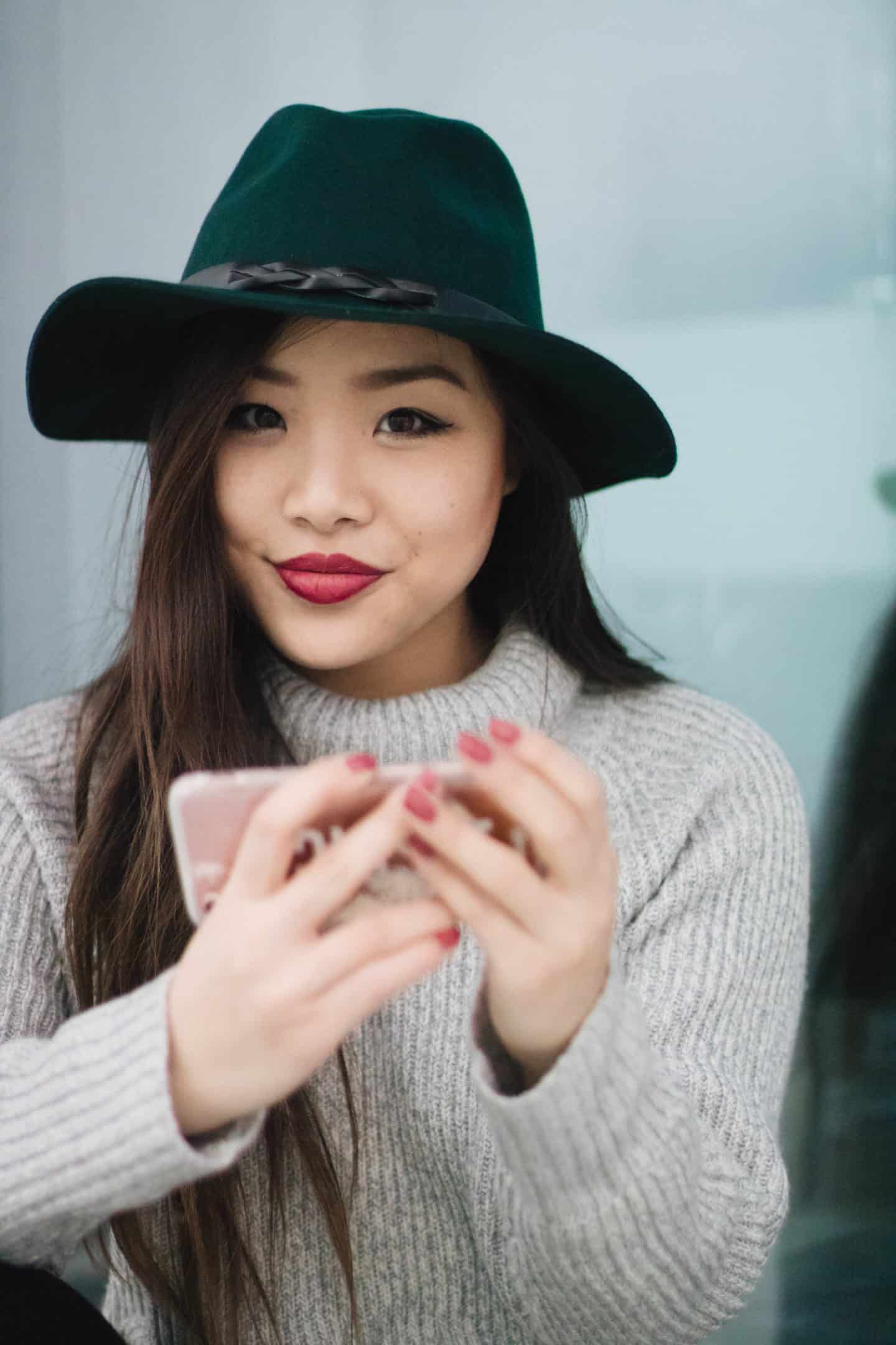 Forest green wide brim hat and grey wool turtleneck sweater for fall