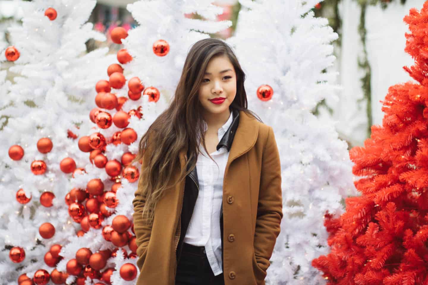 Winter outfit idea featuring a white button down, black leather jacket, brown wool coat, and Levi's dark wash denim