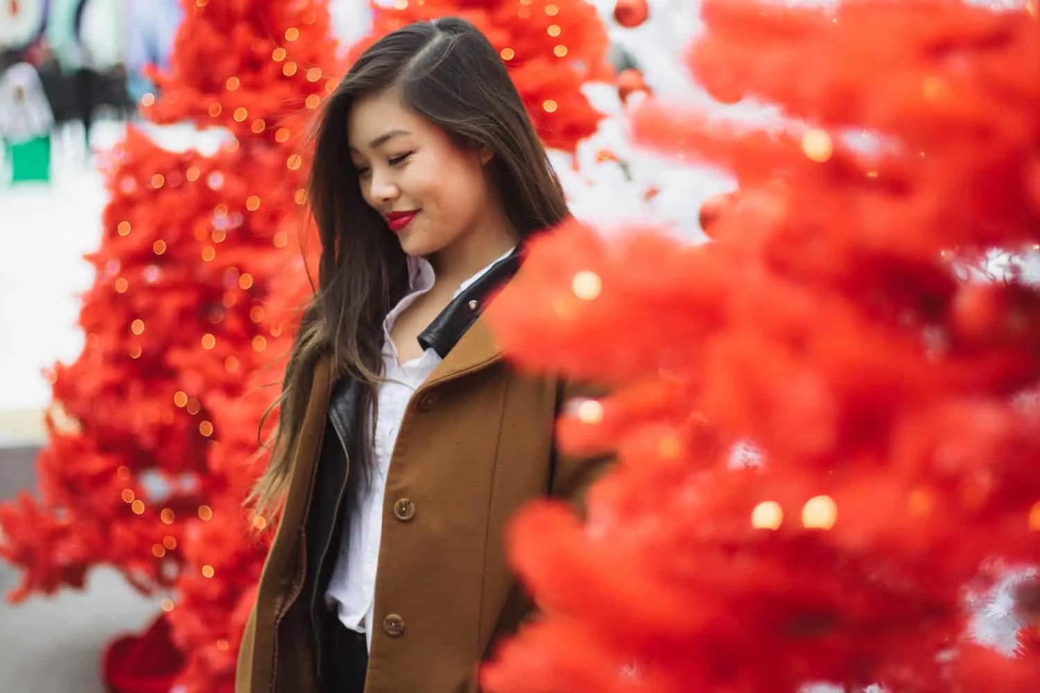 Winter outfit idea featuring a white button down, black leather jacket, brown wool coat, and Levi's dark wash denim