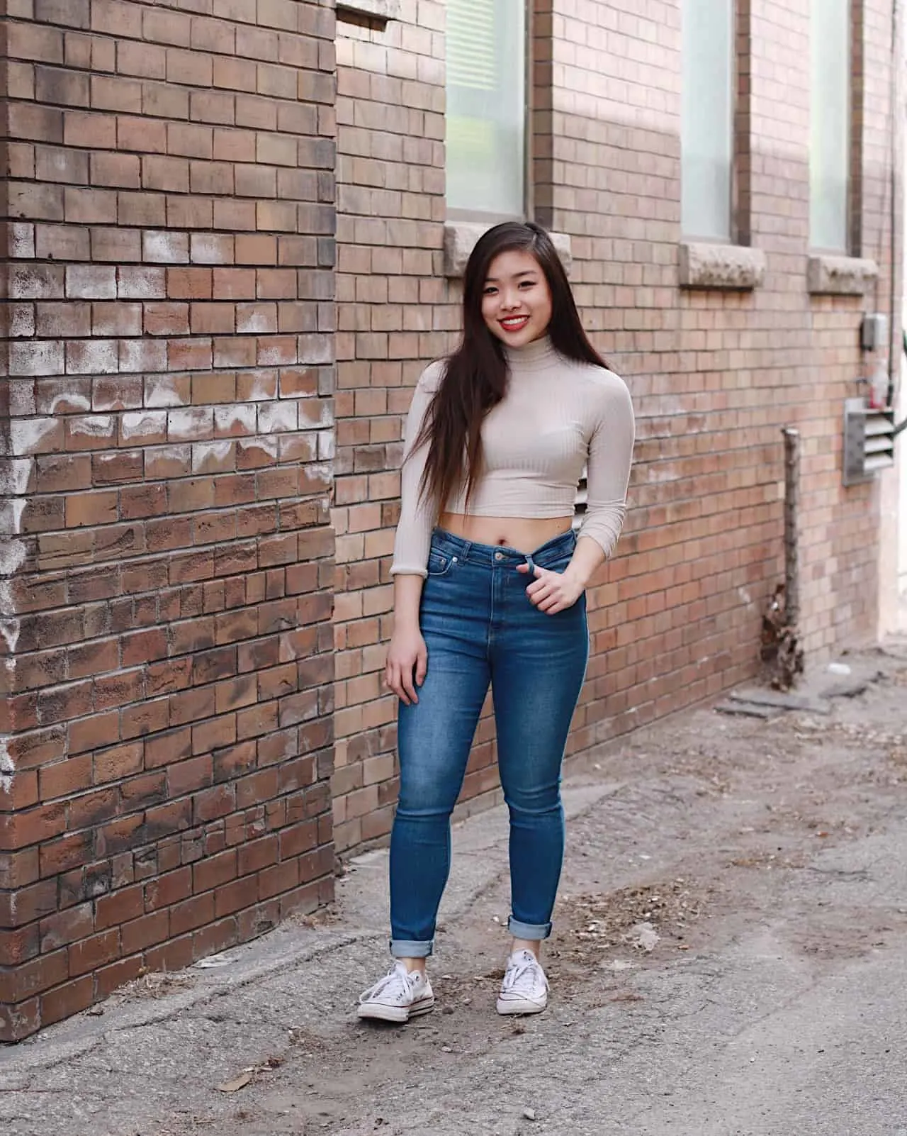 Best jeans for petites | top denim for petite women | how to style high waist jeans for spring | high waisted denim outfit ideas | ivory cropped turtleneck with military green bomber jacket, blue high-waisted denim, and white converse | Diary of a Toronto Girl, a Canadian lifestyle blog