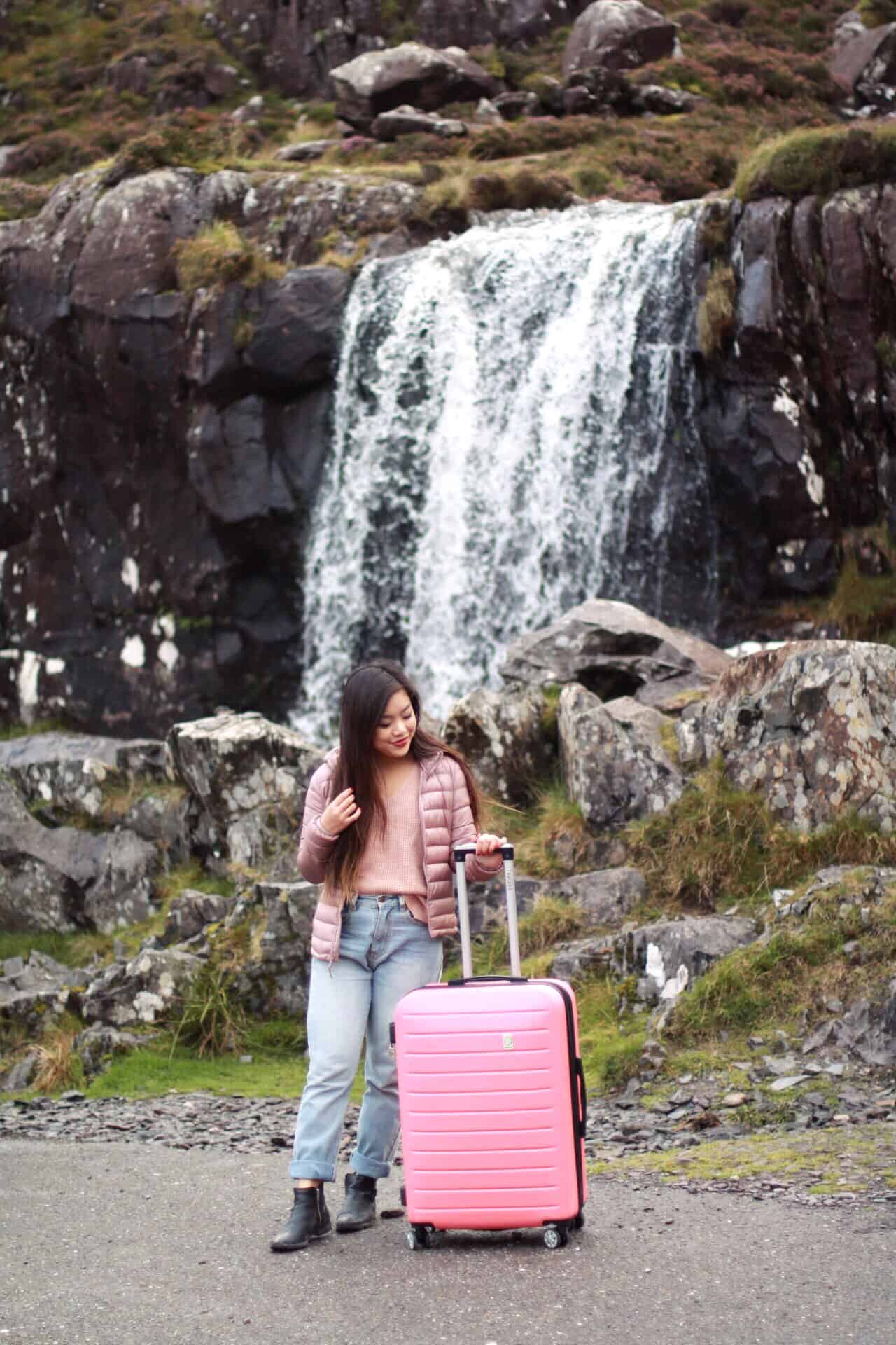 Travel essentials for women to pack in a carry-on luggage | Waterfall in Ireland