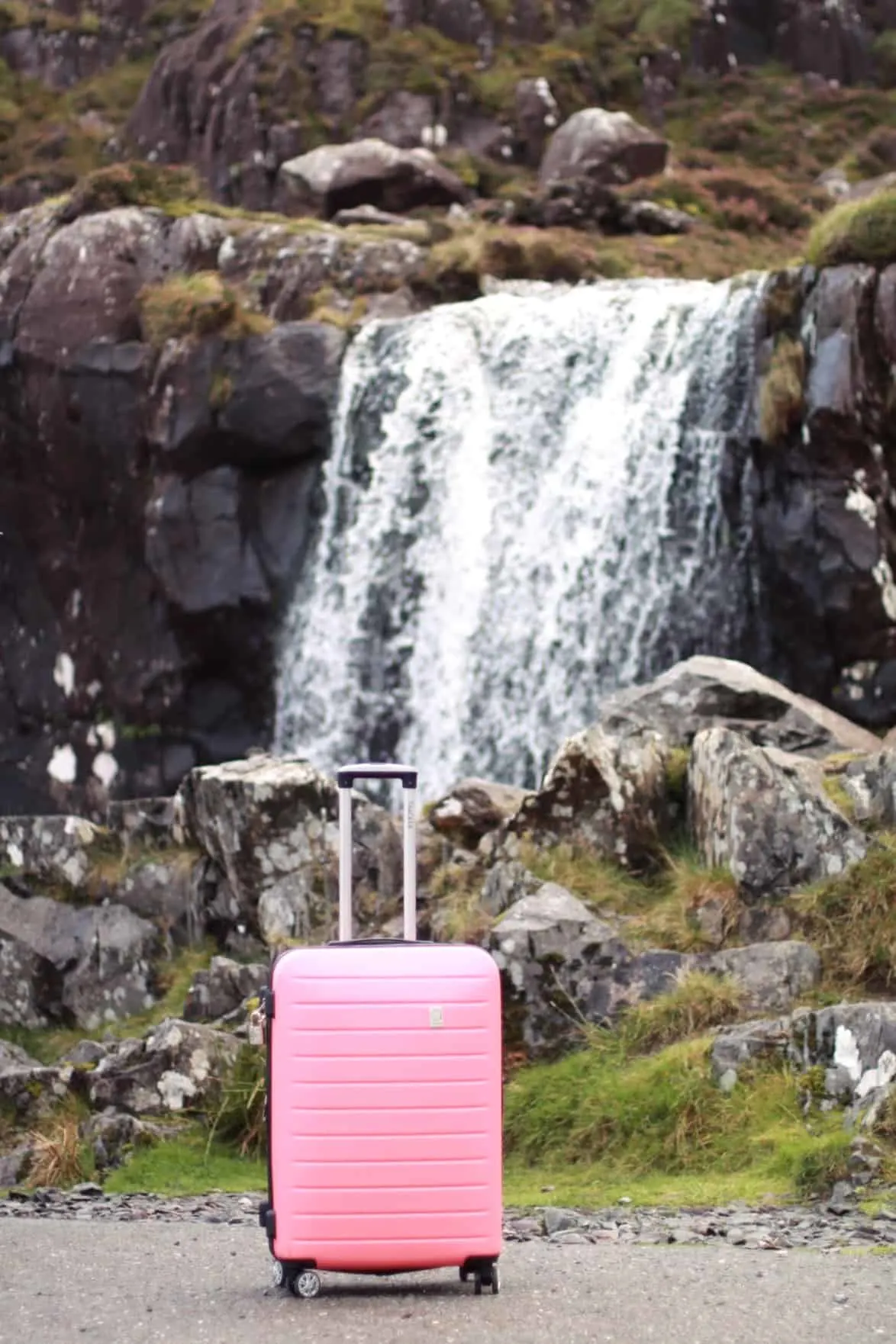 Travel essentials for women to pack in a carry-on luggage | Waterfall in Ireland