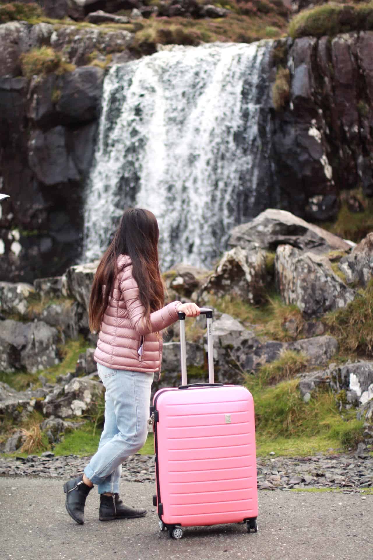 Travel essentials for women to pack in a carry-on luggage | Waterfall in Ireland