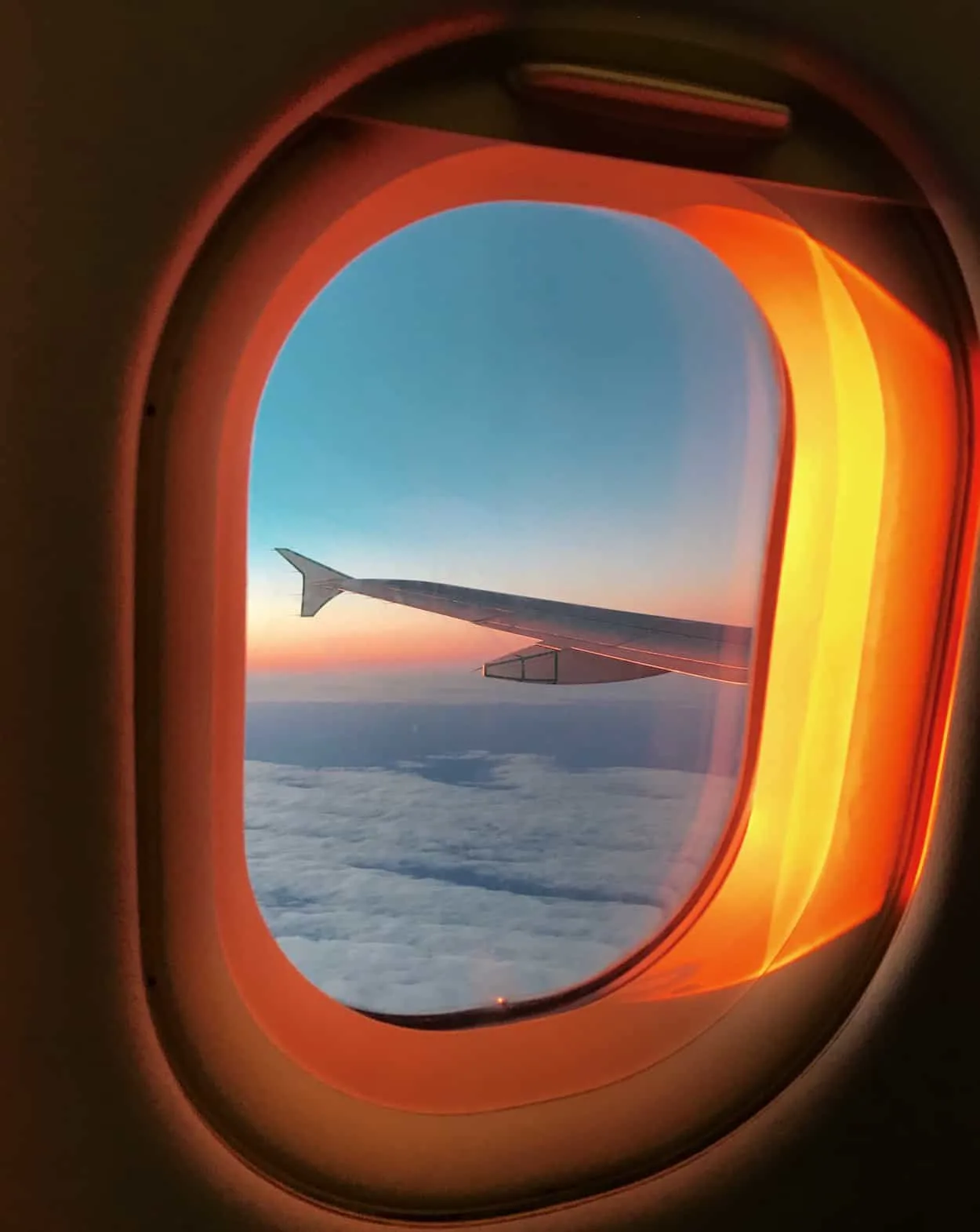 Airplane window during sunrise