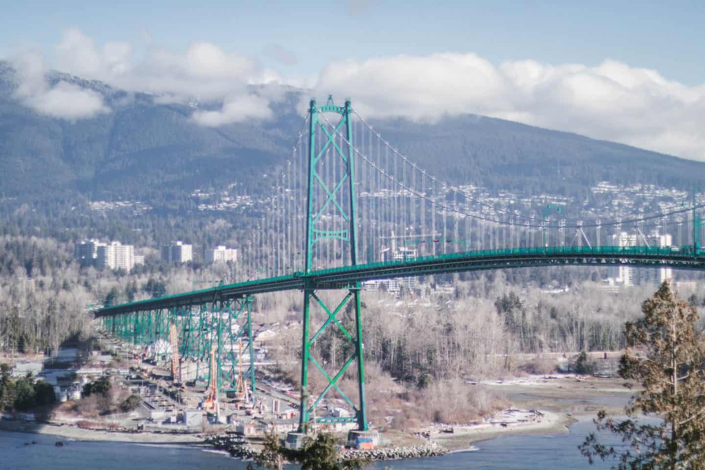 A scenic view of the Lion's Gate Bridge from Stanley Park in Vancouver, British Columbia