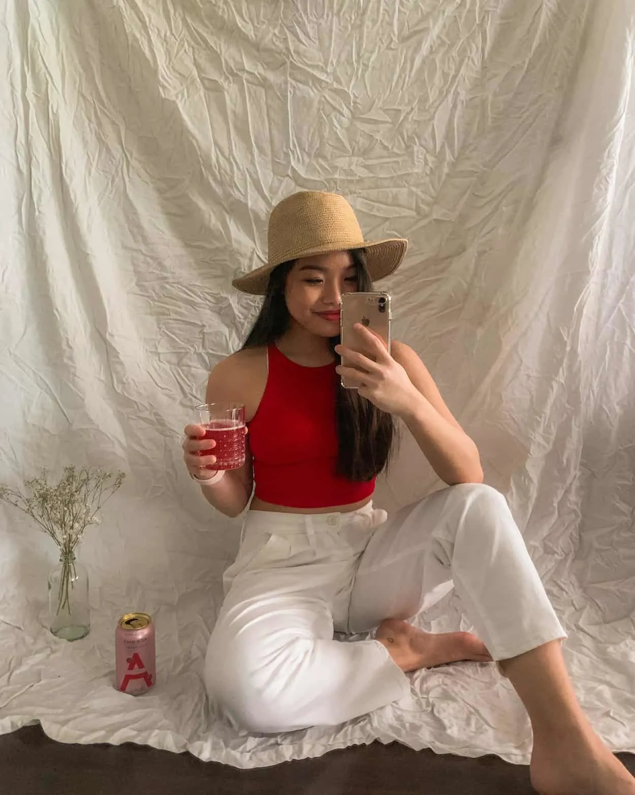 Drinking Ace Hill vodka soda while wearing Aritzia straw hat, American Apparel red crop top, and Levi's white balloon pants
