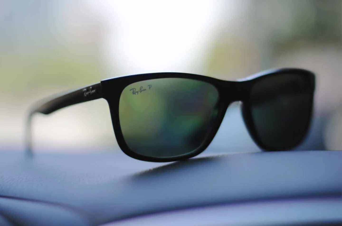 Ray-Ban sunglasses on the car dashboard