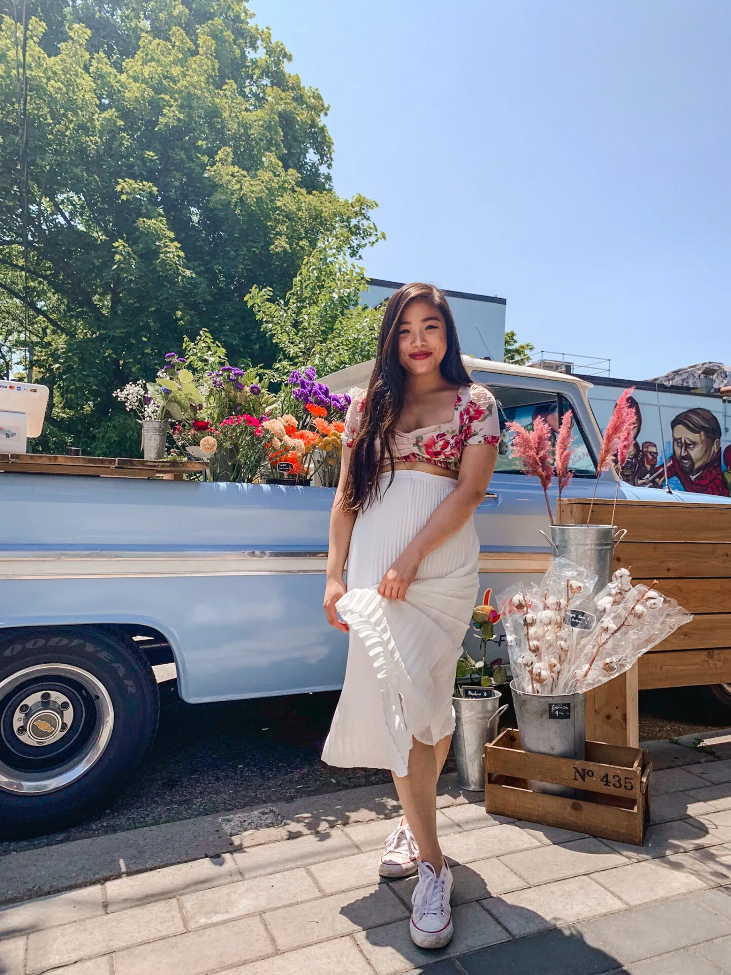 Lou Lou's Flower Truck in Toronto | summer outfit featuring Zara floral crop top, Aritzia pleated midi skirt, white Converse Chuck Taylor sneakers