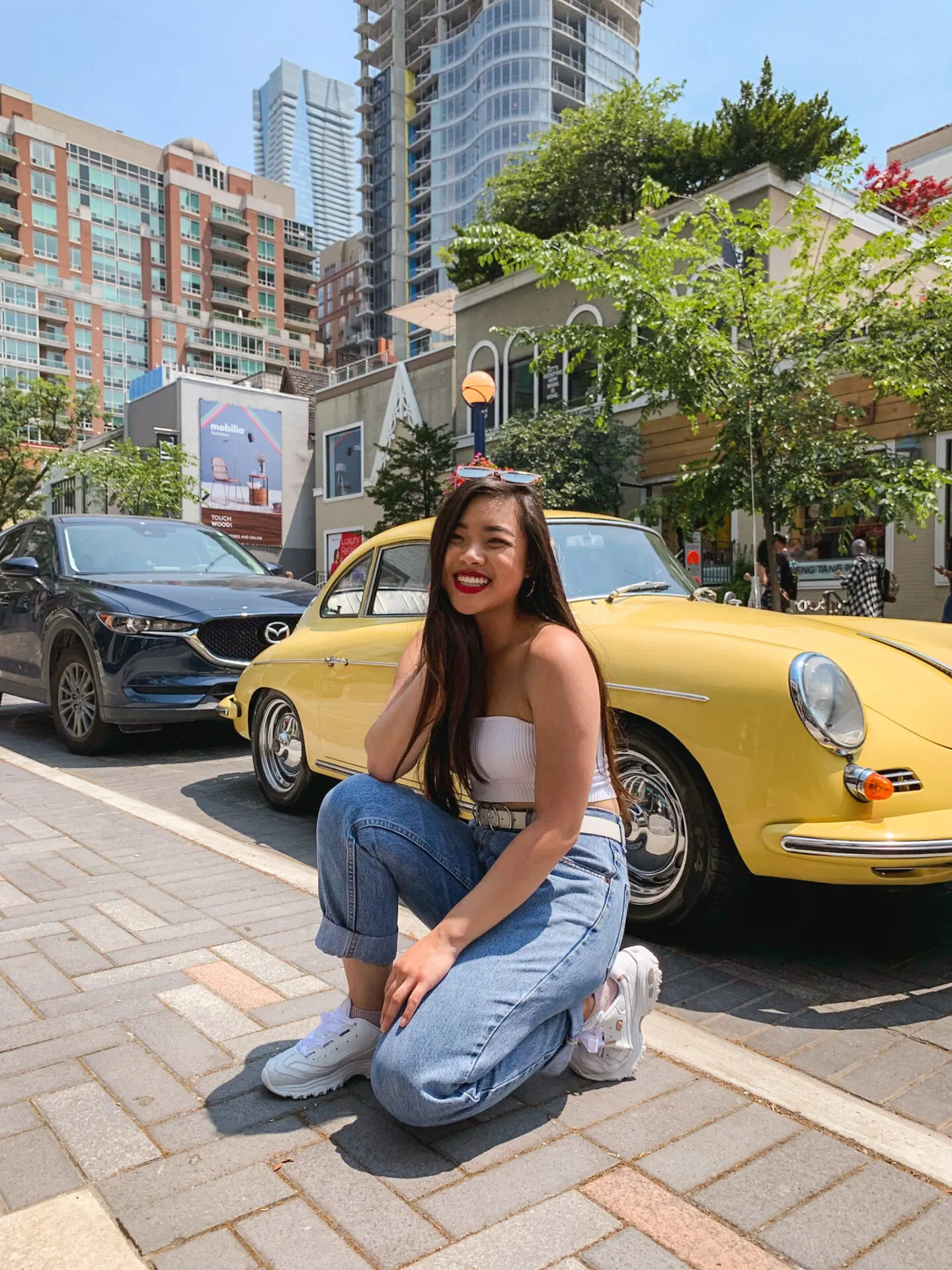 Yorkville Toronto | summer outfit featuring Aritzia white strapless crop top, vintage Levi's jeans, Skechers D'Lite Sneakers