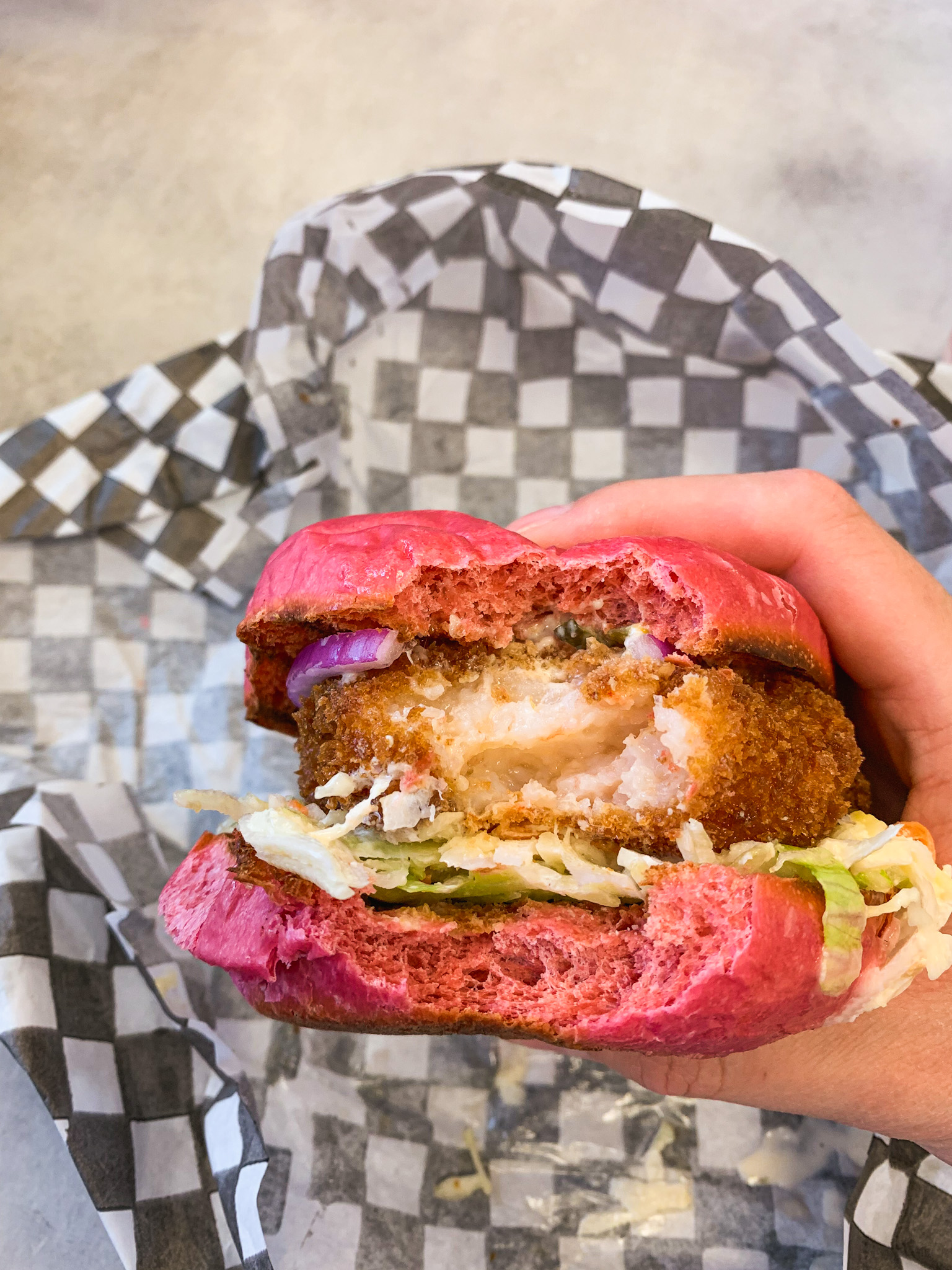 Crispy Shrimp Burger on beet bun from Hong Bo Burger & Poutine inside the First Markham Place food court in Markham, Ontario