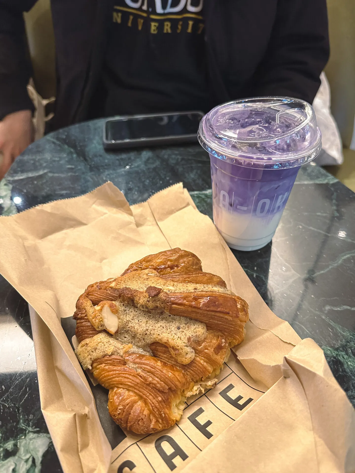 Purple Pop Latte and almond croissant from A-OK Cafe inside Aritzia at Markville Mall in Markham, Ontario